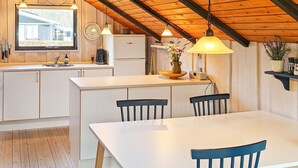 A kitchen with a white countertop, wooden cabinets, a sink, a coffee maker, and a clock on the wall. - Gorgeous home in Ansager with WiFi (Ansager)