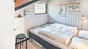 A bedroom with a bed, a stool, a window, and wall-mounted artwork. - Gorgeous home in Ansager with WiFi (Ansager)