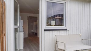 An open door leading to a hallway with a bed and a chair. - Beautiful home in Ystad (Ystad)