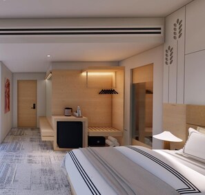 A modern hotel room with a large bed, a small seating area, a wooden wall with a shelf, and a glass door leading to a bathroom. - HOTEL TGR (Ankleshwar)