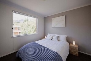 Tabla de planchar con plancha y ropa de cama 