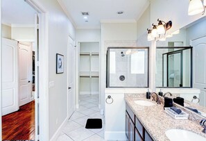 A modern bathroom with two sinks, a large mirror, and a shower area. - 111 3BR The R&R Uptown Galleria Dream House 121 (Houston)