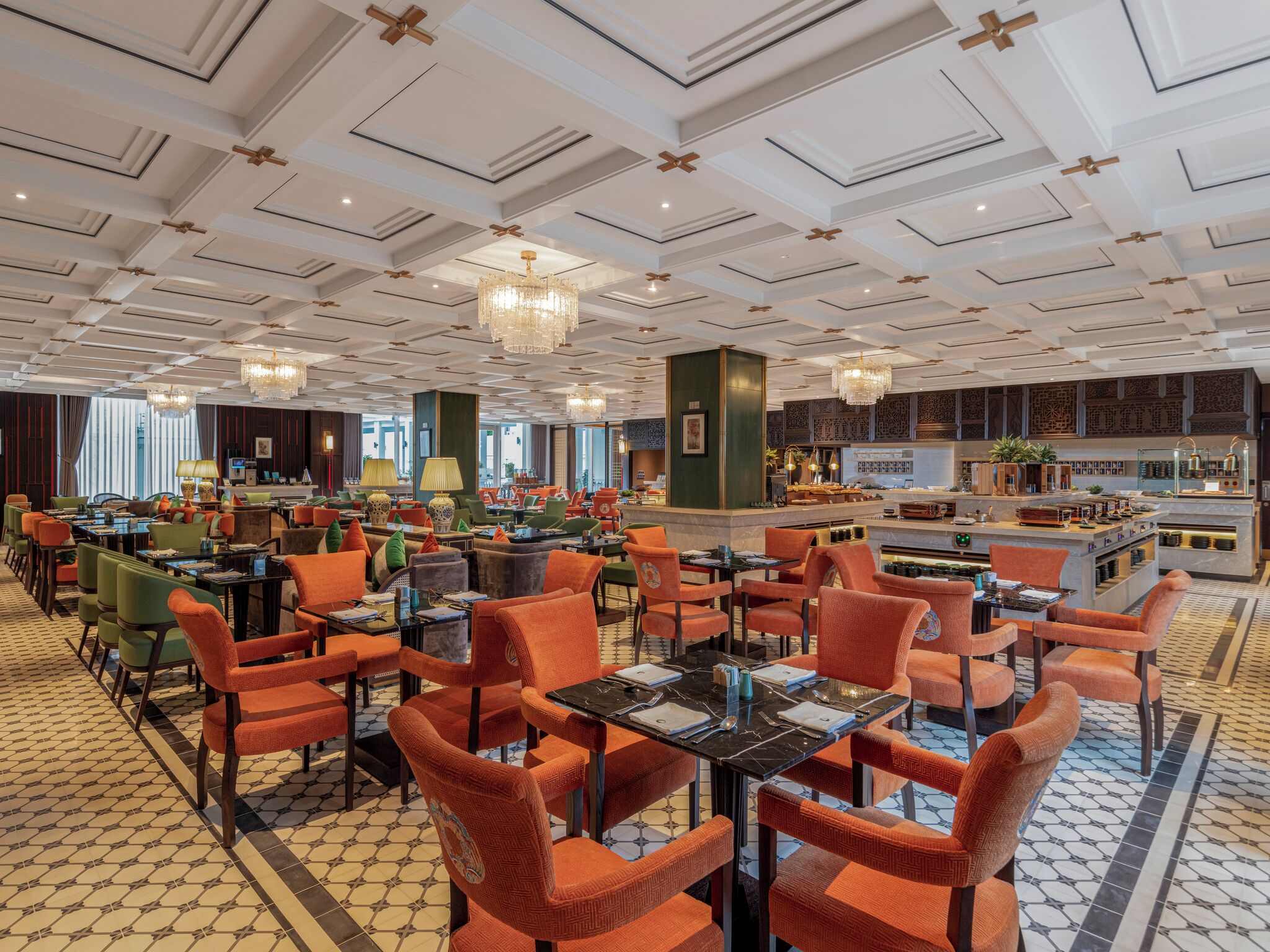 A spacious hotel lobby with multiple seating areas, a bar, and a view of the cityscape.