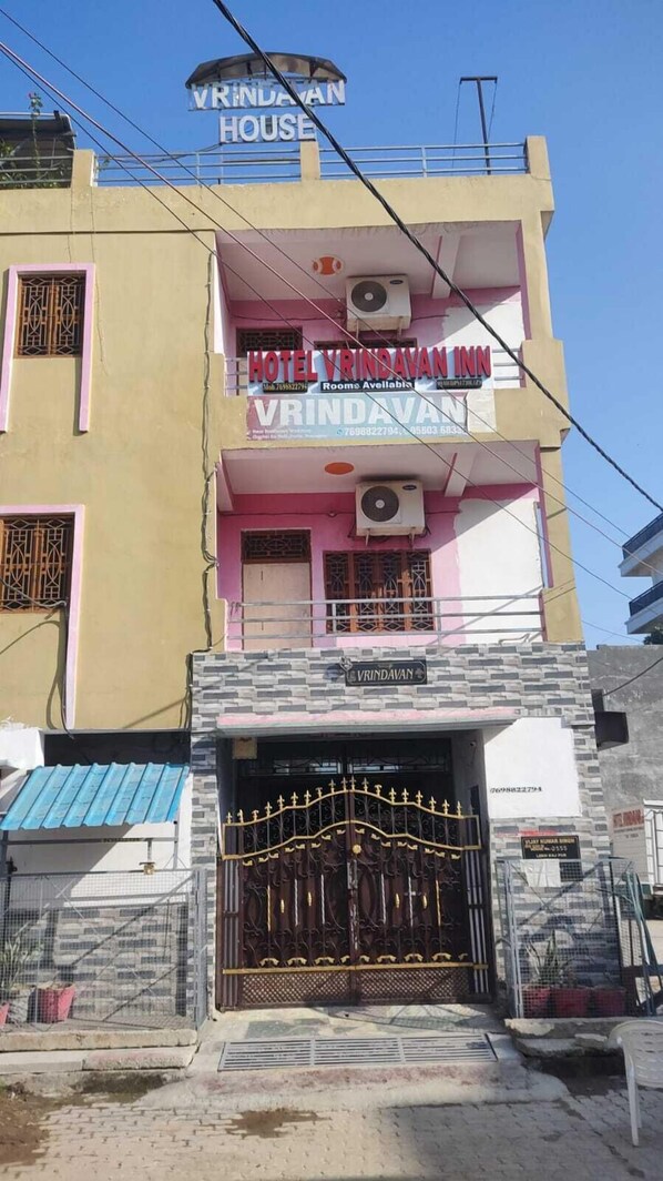 A multi-story building with a sign for 'Hotel Vrindavan Inn' and a gated entrance. - Hotel Vrindavan Inn (Phulpur)