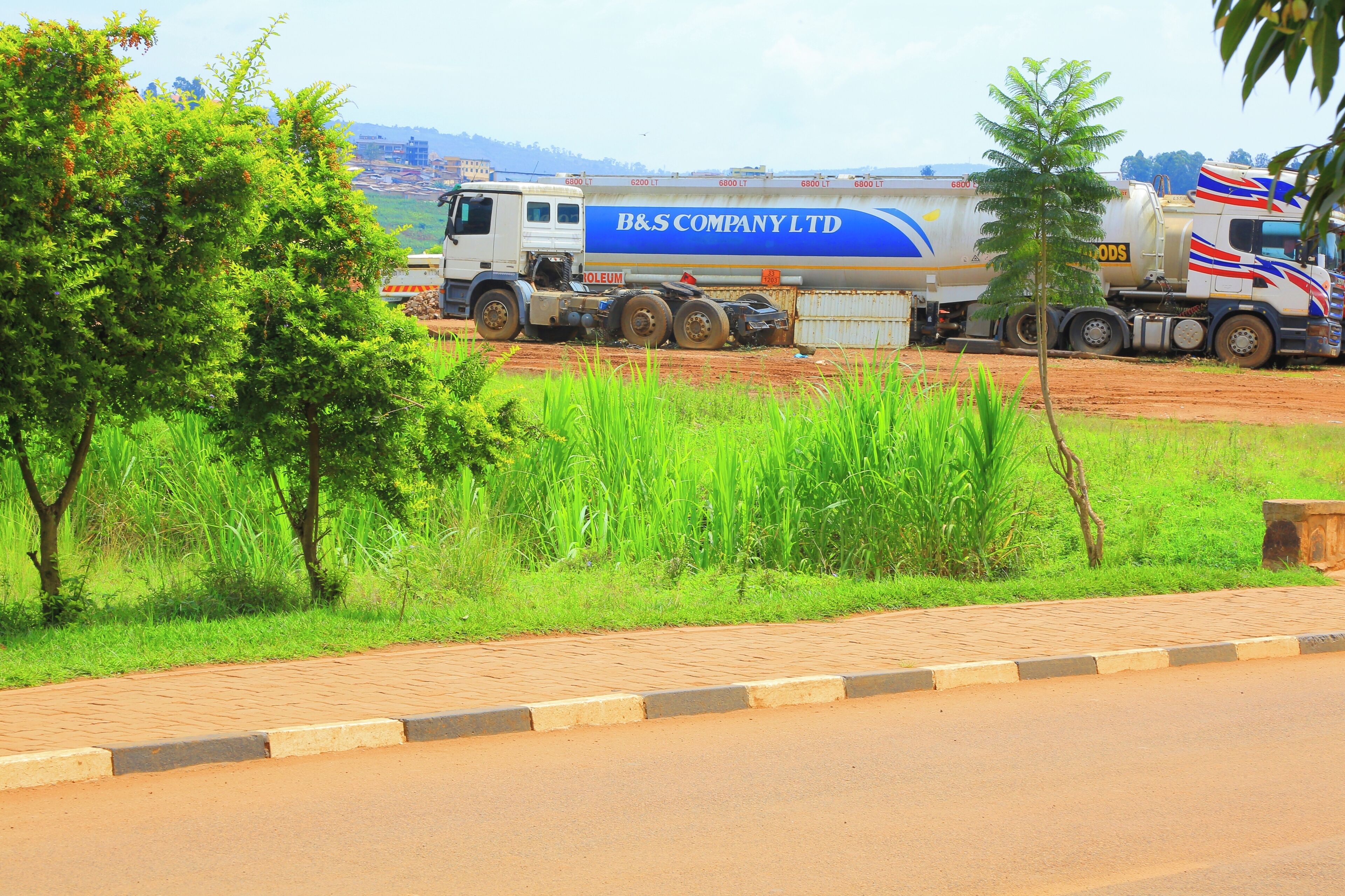 A road with a large truck parked on the side.