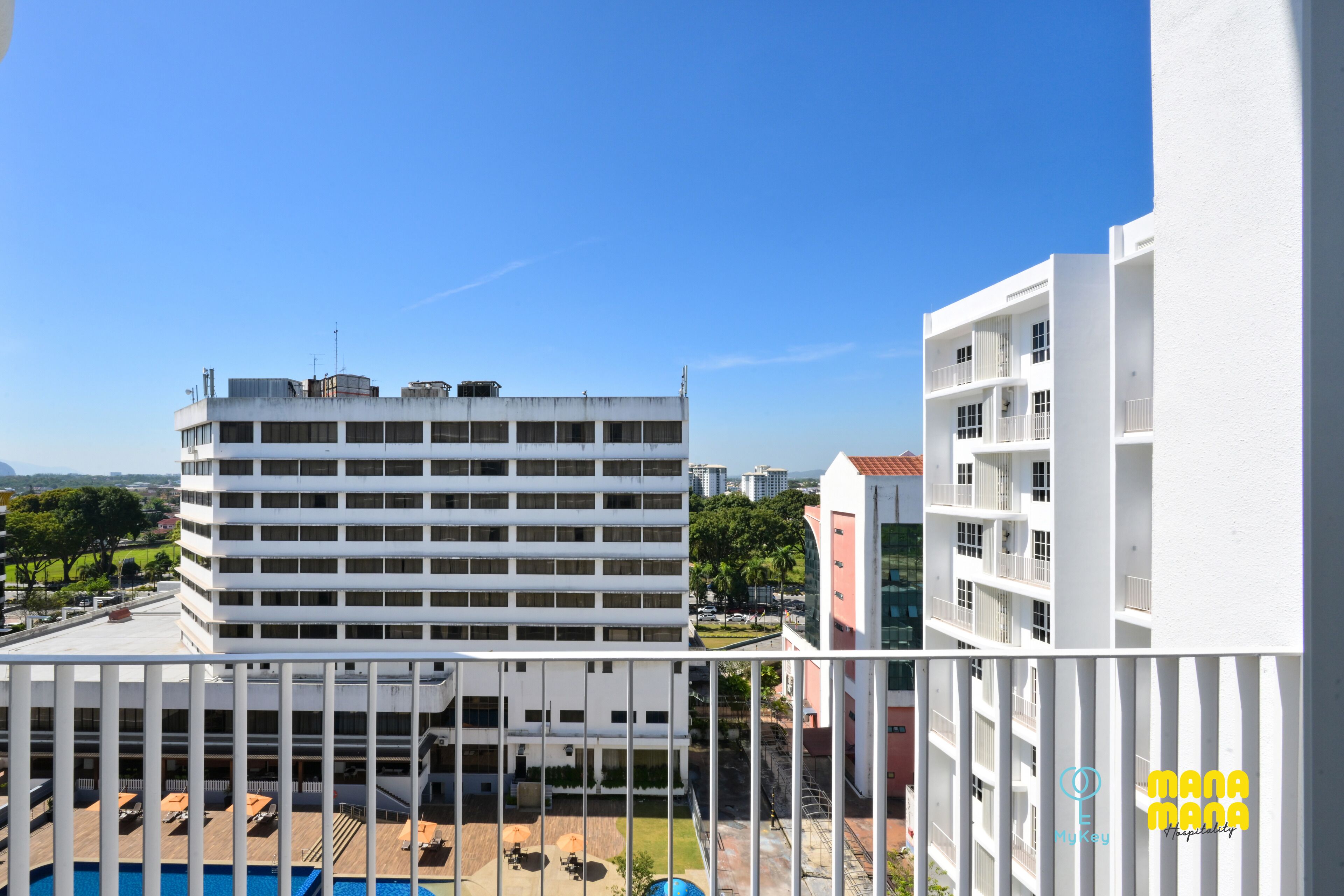 A high-rise building with multiple balconies and a rooftop area.