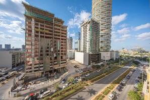A multi-story building under construction with visible scaffolding and construction vehicles. - StayShort - Stylish 1-Bedroom Retreat in JVC that Sleeps 2 (JVC)