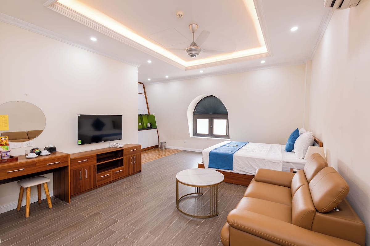 Deluxe Studio Suite, Balcony, City View | Living area | 43-inch TV with digital channels