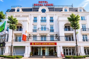 A large, white hotel with balconies and a sign reading 'ROYAL LOUIS HOTEL'. - Royal Louis Hotel (Hanoi)