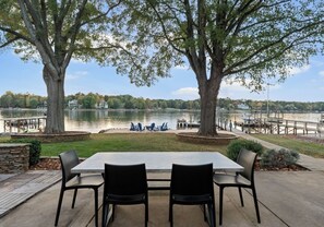 Outdoor dining area. - Lake Norman Lakefront w/ Private Beach, Dock, Hot Tub & Fire Pit | Sandy Shore (Mooresville)