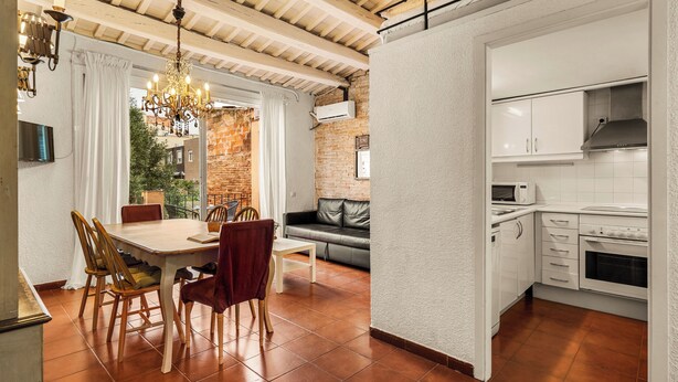 A modern kitchen with white cabinets, a built-in oven, and a microwave. - Gràcia Loft + Terrace BBQ • AC & Fiber Wi-Fi (Barcelona)