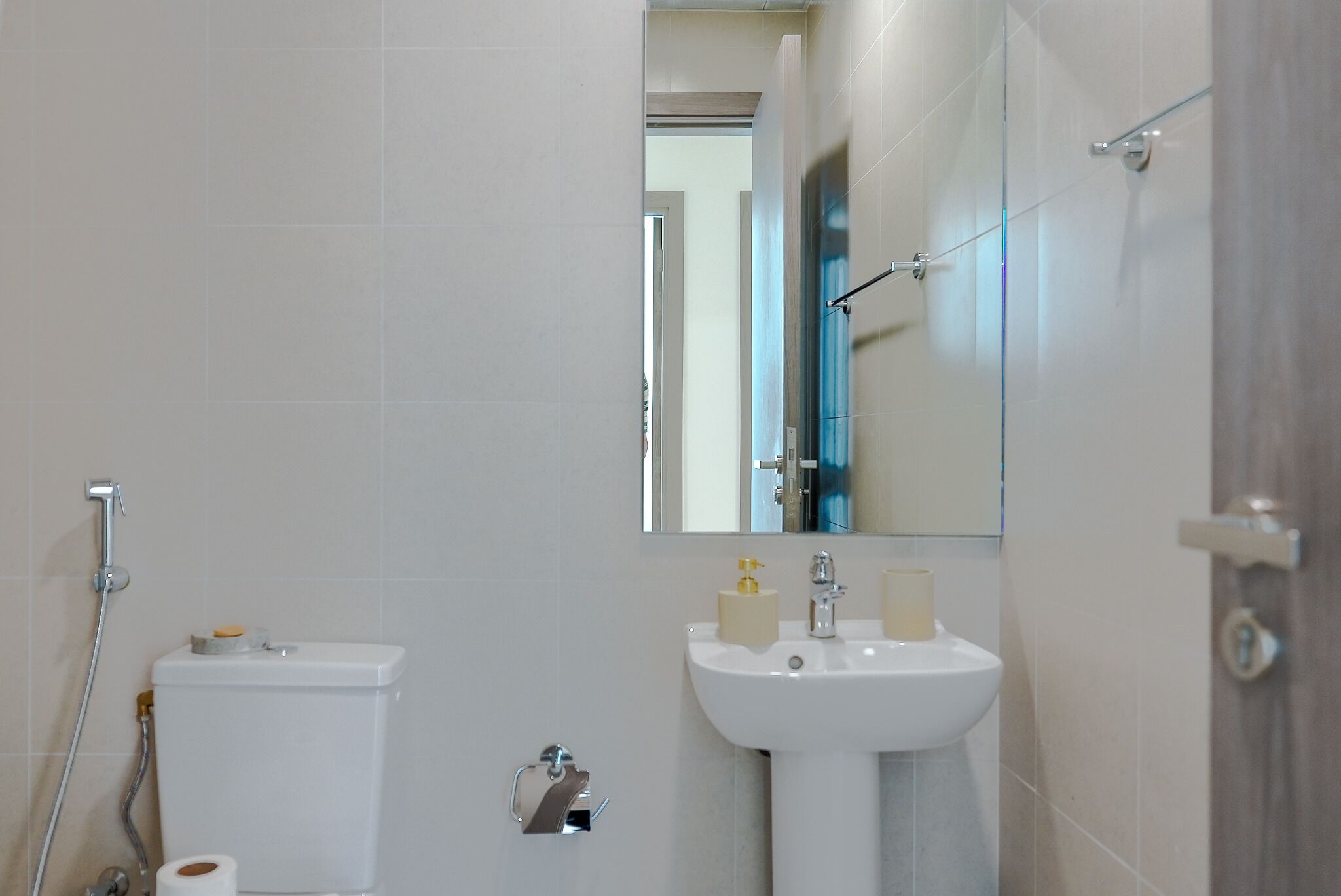 A bathroom with a toilet, sink, and shower.