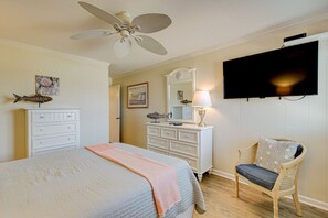 A bedroom with a bed, dresser, chair, television, and ceiling fan. - 2BR/2B Oceanfront & Inlet View Gated w/pool (North Myrtle Beach)