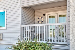 A house with a porch, a life ring, and a ladder. - Inlet Facing 1st Floor 2B/2B Condo w/pool (North Myrtle Beach)
