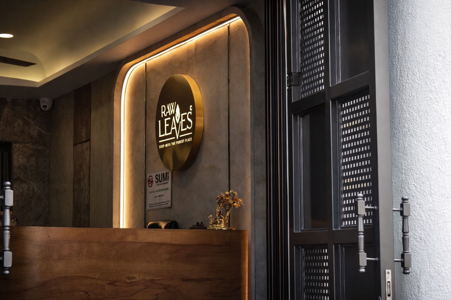 A reception desk with a wooden counter and a sign that reads "Dawn Leaves."