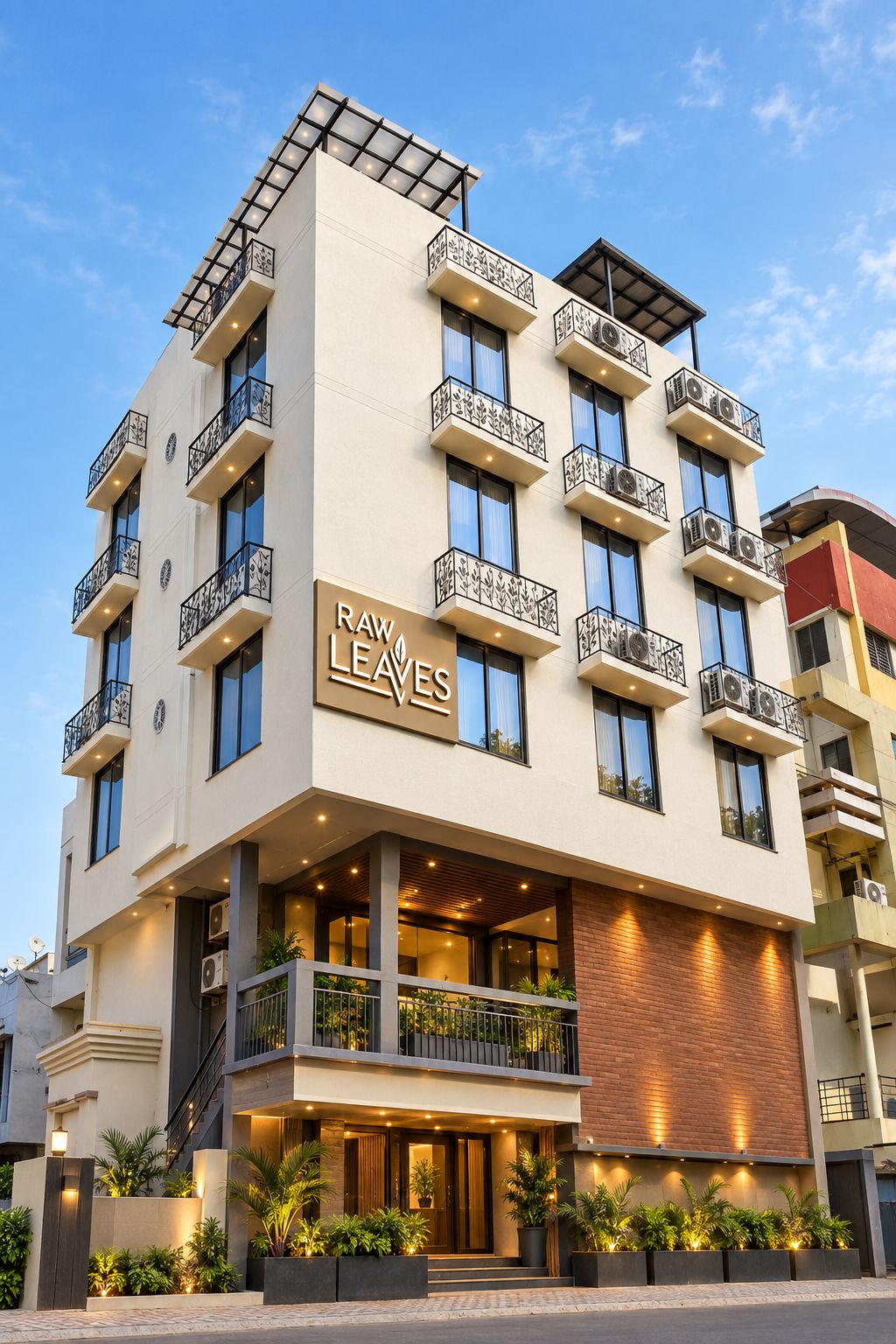 A multi-story hotel with balconies, a sign reading 'RAW LEAVES,' and a modern architectural design.