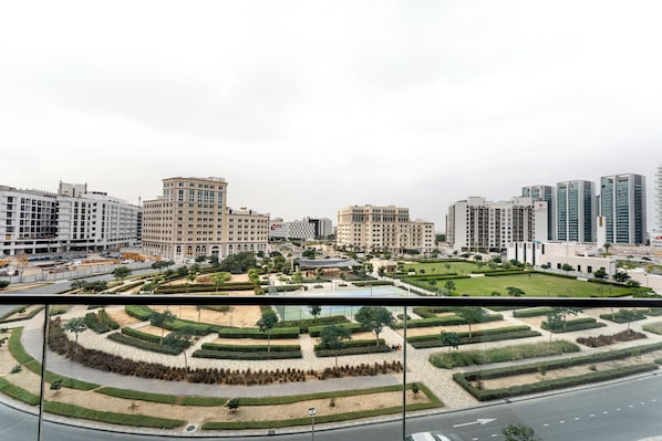 Luxury Studio, Courtyard View | Balcony - Oxford Gardens Studio Cinema Game Room (Dubai)