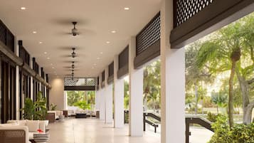 Unwind in the breezy open-air lobby with plush seating.