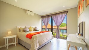 A bedroom with a bed, bedside table, and a desk. - Modern 3-Bed Home with Pool Access, Ballito (Ballito)
