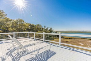 A wooden deck with white railings overlooking a body of water and trees. - Faded Blue - 3 BR Soundfront Home in Channelbend (Surf City)