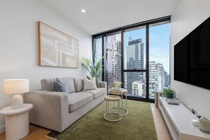 TV, books - Designer 1BR + Sofa Bed in Aspire | Skyline Views (Melbourne)