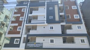 Een meerlaags woongebouw met balkons, serviceappartementen, en een bordje dat het een residentie retraite aanduidt.
