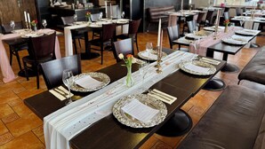 A restaurant with tables set for dining, featuring elegant table settings and a modern interior design. - Hotel Stará pošta (Zdiby)