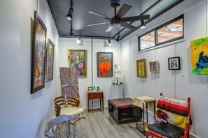 A gallery space with artwork on the walls, a ceiling fan, and a window providing natural light. - 5 Mi to Coors Field & Lodo: North Denver Studio (Denver)