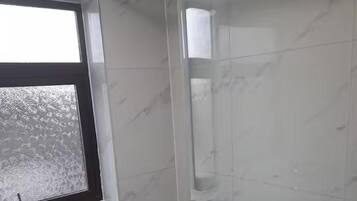 Combined shower/bathtub, deep-soaking bathtub, towels