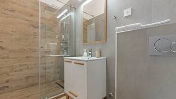 Suite studio Deluxe, non-fumeur, salle de bain privée | Salle de bain | Douche, séchoir à cheveux, pantoufles, serviettes fournies