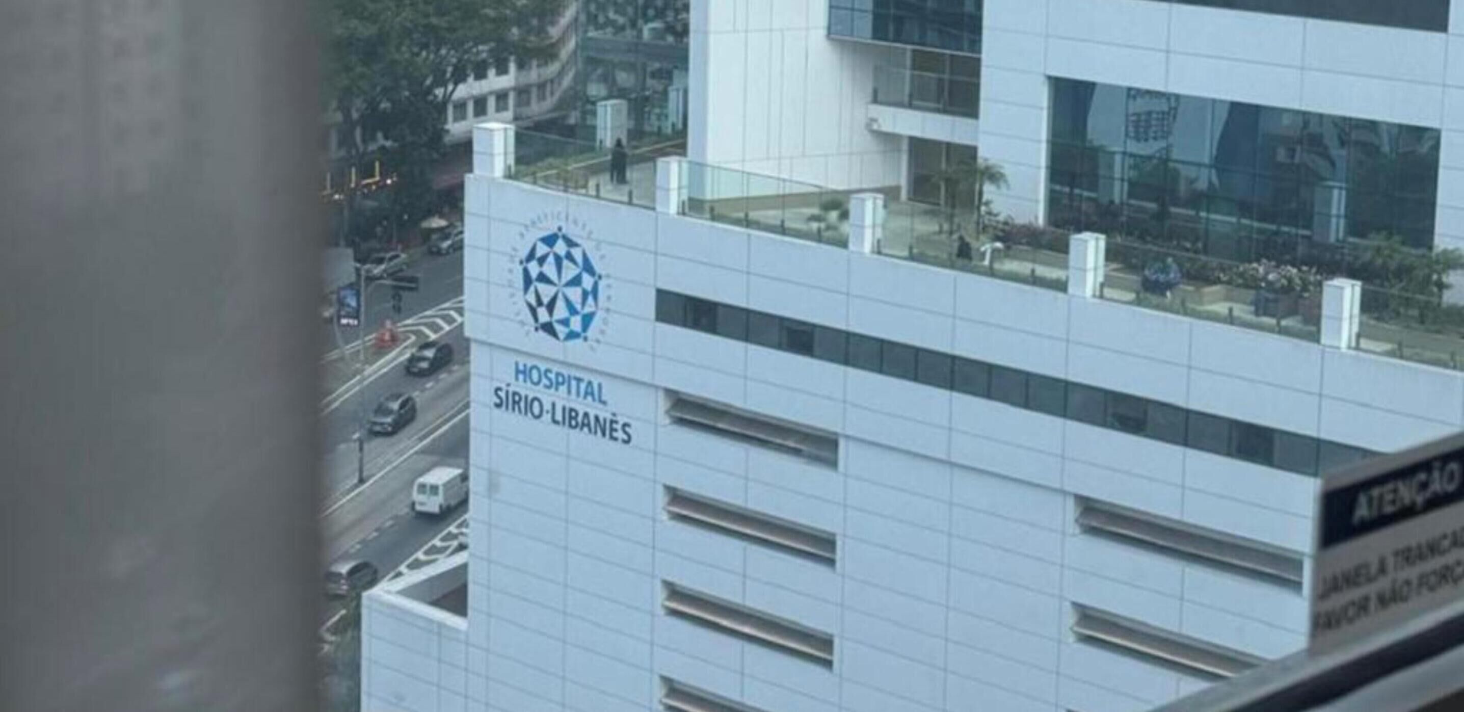 A hospital building with a modern design, featuring a prominent logo and signage.