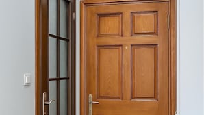 A wooden door with a glass panel and a metal handle. - PeraHomes (İstanbul)