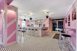 A bar area with a counter, stools, and a neon sign. - Summer 35% Off 3BR Disney Area Villa (Kissimmee)