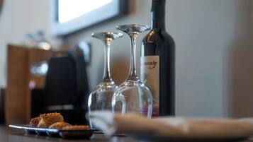 A table with two wine glasses, a wine bottle, and a plate with food.