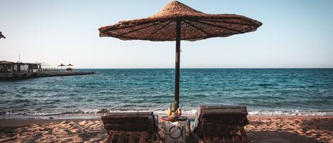 Private beach, beach umbrellas, beach towels, beach yoga