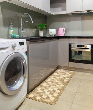 Fridge, stovetop, cleaning supplies, freezer - D1MENSION Iconic Central Luxury Living (Ho Chi Minh)