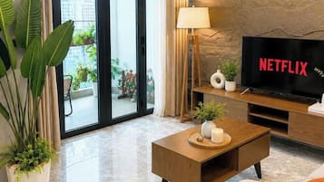 Deluxe Apartment, 3 Bedrooms, Pool Access, City View | Living area | Flat-screen TV
