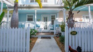 A house with a white picket fence, a front porch, and a number sign. - Angel Fish Cove | Updated Townhome Retreat Near Duval (Key West)