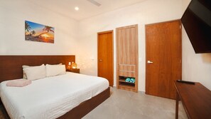 A bedroom with a bed, a nightstand, a wall-mounted TV, and a wooden wardrobe. - Work & Relax apto fast wifi (Tulum)