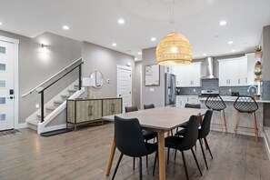 Gather around your spacious dining table in this beautifully designed open-plan space, where modern elegance meets comfort for memorable meals. - Modern 4BR Bellingham Home w/ Deck & Garage (Bellingham)