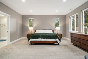 Sink into this primary bedroom where soft gray walls and plush carpeting create your peaceful retreat after exploring the day. - Modern 4BR Bellingham Home w/ Deck & Garage (Bellingham)