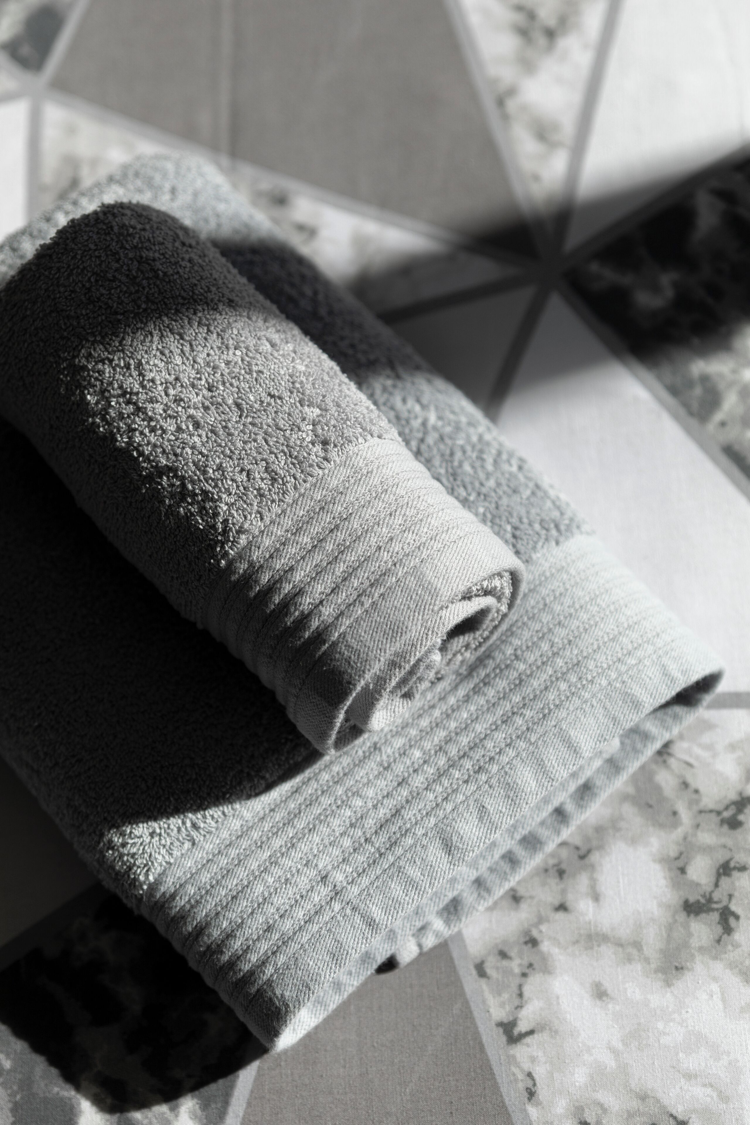 A rolled towel on a marble surface.
