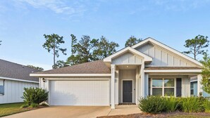 A single-story residential house with a garage, a front door, and a small porch area. - Family-Friendly Retreat Near Gulf Shores, Beach (Foley)