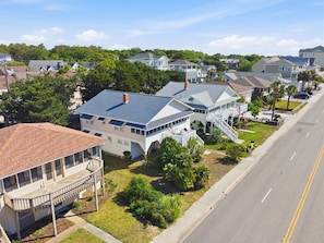 A residential neighborhood with houses, a street, and a clear sky.