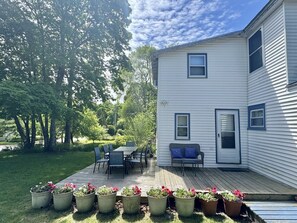 A two-story house with a deck, outdoor furniture, and potted plants. - Cedar Heart-Downtown Bar Harbor off street parking (Bar Harbor)
