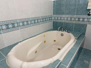 Shower, jetted tub, towels, soap