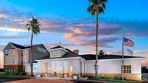 A hotel with a modern architectural design, featuring a prominent sign for "Homewood Suites." - Homewood Suites By Hilton Corpus Christi Downtown (Corpus Christi)