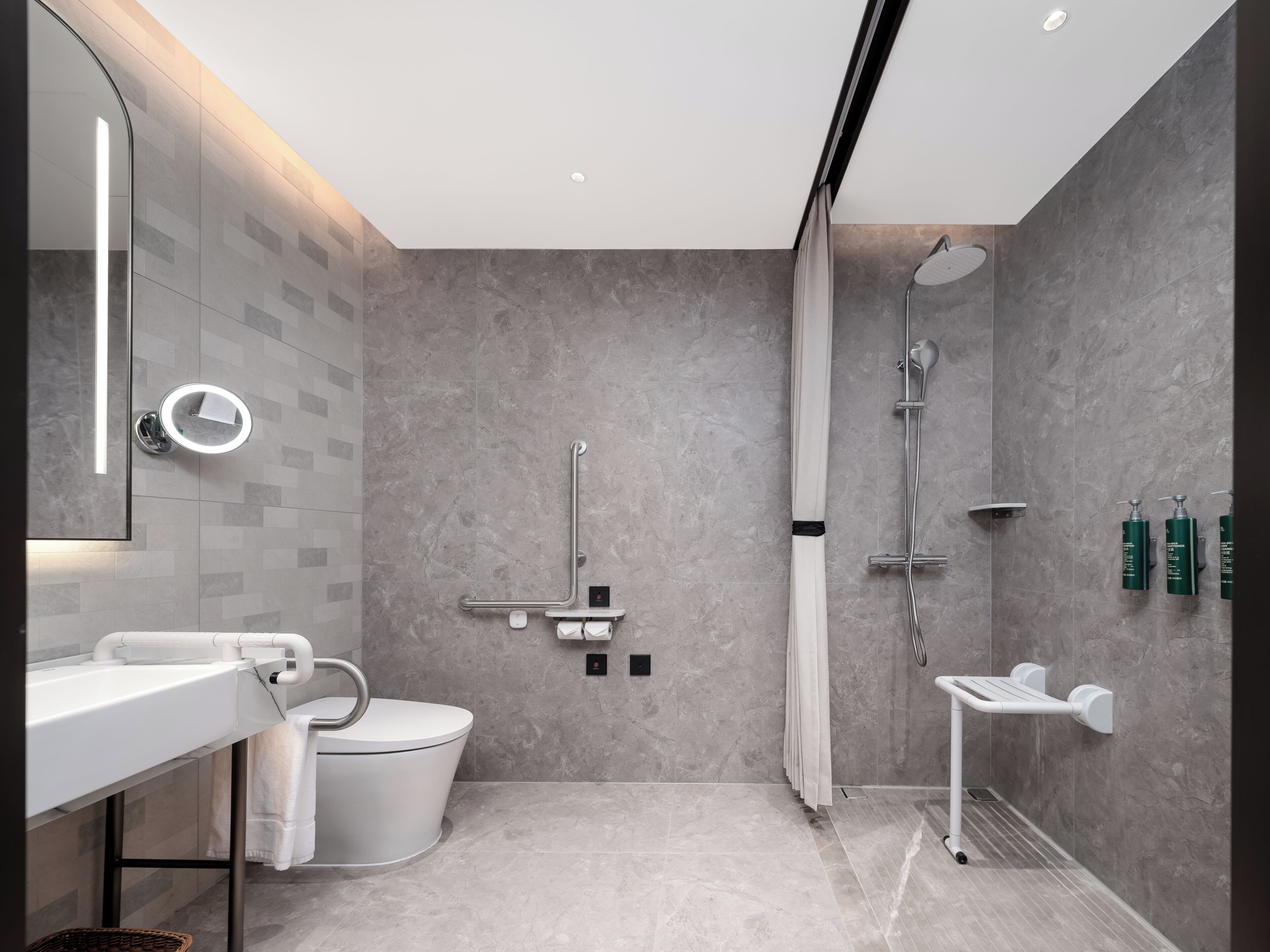 A modern bathroom with a toilet, sink, and shower.
