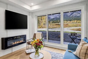 TV, fireplace - Brand New 1BR Canmore Retreat: Hot Tub, Sauna, Gym (Canmore)