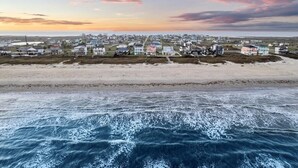 Ein Küstenort mit Strandhäusern und Blick auf den Ozean.